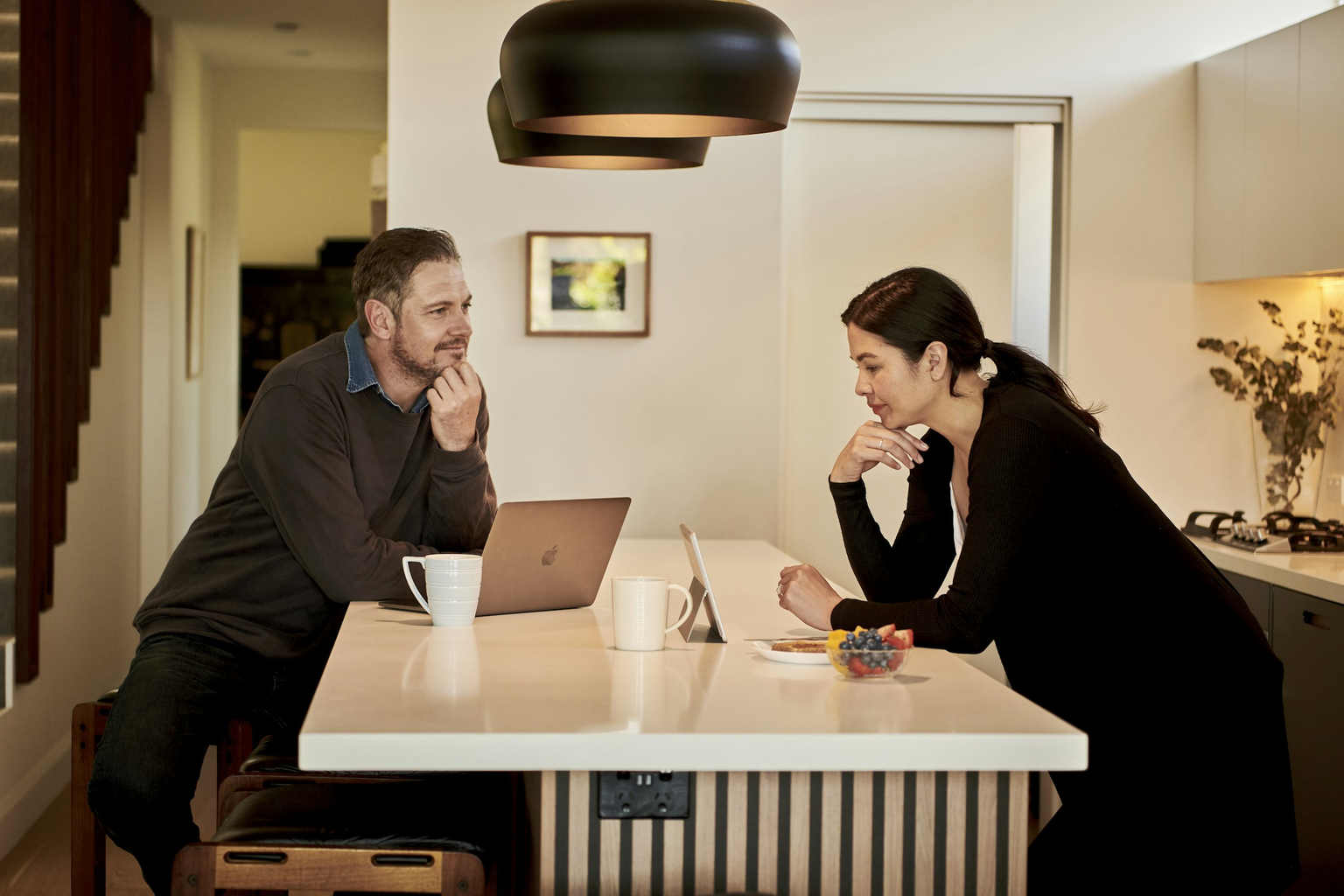 Two team members collaborating over a laptop at Cebridge Digital
